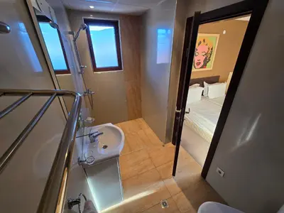 a bathroom with a sink and a shower and a sink at Bansko Apartment Next To The Ski Lift in Bansko