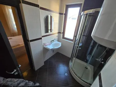 a small bathroom with a sink and a shower at Bansko Apartment Next To The Ski Lift in Bansko