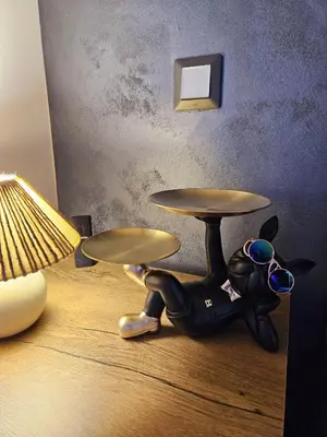 a dog with sunglasses sitting on the floor next to a table at ELIA Apartment in Bansko