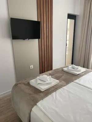 a bedroom with a bed with two towels on it at Infinity Park Apartment in Sandanski