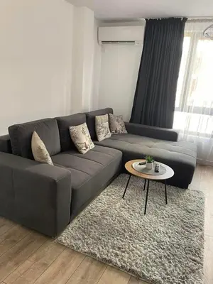 a living room with a couch and a table at Infinity Park Apartment in Sandanski