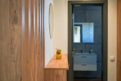 a bathroom with a wooden counter and a sink at Апартамент за Гости Танчеви in Karlovo