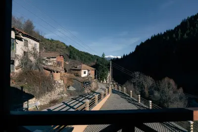 a view from a window of a mountain with a road at Къща за гости 'Кадийца' in Sushitsa