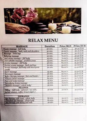 a menu for a restaurant with candles on it at Belvedere Holiday Club F403 in Bansko