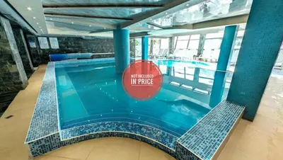 a swimming pool with a sign that reads not rooted in refuge at Belvedere Holiday Club F403 in Bansko