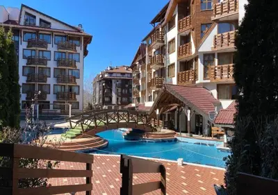 a bridge over a swimming pool next to some buildings at Belvedere Holiday Club F403 in Bansko