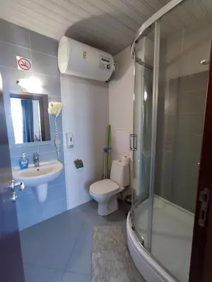 a bathroom with a shower and a toilet and a sink at Belvedere Holiday Club F403 in Bansko