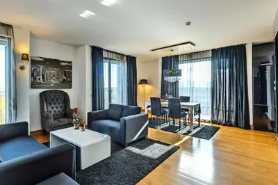 a living room with a couch and a table at Capital City Center Apart Residence in Plovdiv