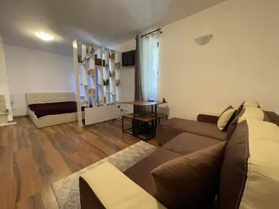 a living room with a couch and a table at Montepinar Apartment Grand Resort Pamporovo in Pamporovo