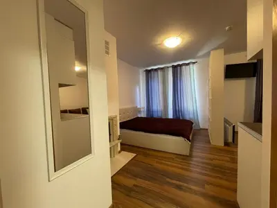 a small room with a bed and a window at Montepinar Apartment Grand Resort Pamporovo in Pamporovo