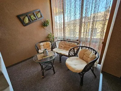 a living room with two chairs and a table at Family Hotel Jeri in Velingrad