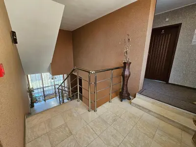 a hallway with a staircase with a vase at Family Hotel Jeri in Velingrad