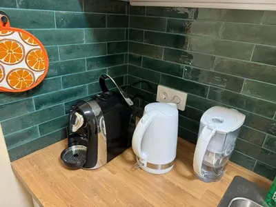 a kitchen counter with a toaster and a coffee maker at Guest Apartment Elina in Smolyan