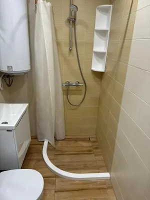 a bathroom with a shower with a toilet and a sink at Guest Apartment Elina in Smolyan