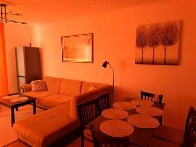 a living room with a couch and a table at Sun and view cozy apartment in Razlog
