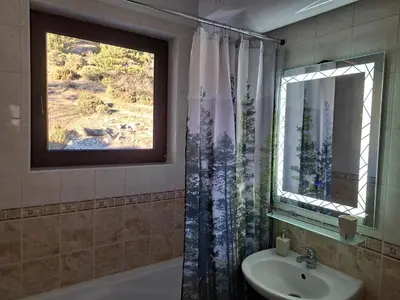 a bathroom with a sink and a window at Sun and view cozy apartment in Razlog