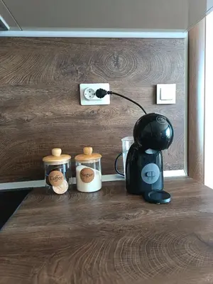 a table with a coffee maker and containers on it at Boutique apartment green 2 in Plovdiv