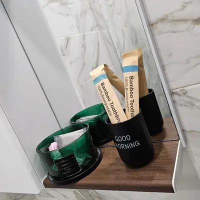 two black cups sitting on a wooden shelf in a bathroom at Boutique apartment green 2 in Plovdiv