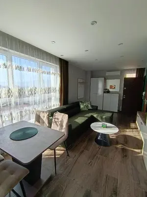 a living room with a couch and a table at Boutique apartment green 2 in Plovdiv