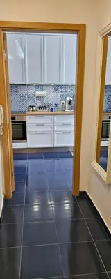 a kitchen with white cabinets and a large window at Boutique Apartment blue 3 in Plovdiv