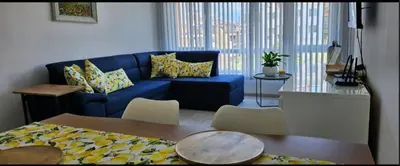 a living room with a blue couch and a table at Boutique Apartment blue 3 in Plovdiv