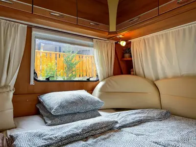 a small room with a bed and a window at Къмпинг Alino Lake in Alino