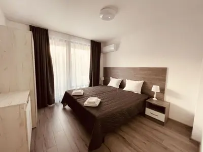 a bedroom with a bed and a large window at Apart2bedroomslux in Sofia