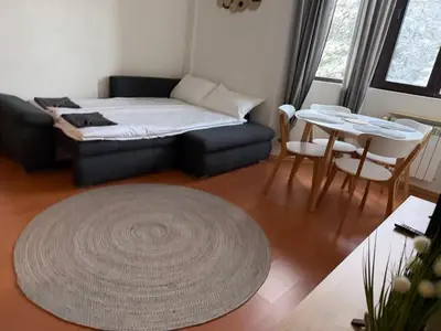 a living room with a couch and a table at SnowLine Flora in Borovets