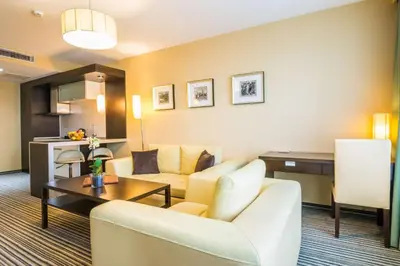 a living room with a couch and a table at Best Western Plus Olives City Hotel - Free Pool & Parking in Sofia