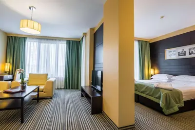 a hotel room with a bed and a chair at Best Western Plus Olives City Hotel - Free Pool & Parking in Sofia