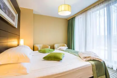 a bedroom with two beds and a large window at Best Western Plus Olives City Hotel - Free Pool & Parking in Sofia