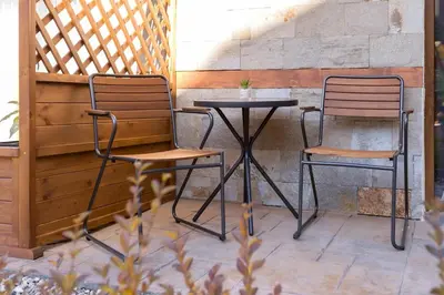 two chairs and a table on a patio at Divine mountain studio - parking - SPA in Bansko