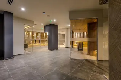 a lobby with glass doors and a tile floor at Divine mountain studio - parking - SPA in Bansko
