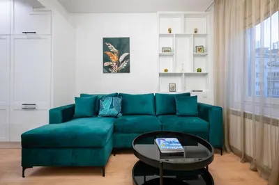 a living room with a blue couch and a table at Sunny Stylish Apartment in Sofia by Flat Mаnager in Sofia