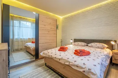 a bedroom with a bed with two towels on it at Lotus apartments with free parking in Sofia