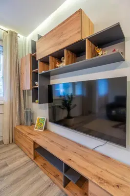 a large entertainment center with a large flat screen tv at Lotus apartments with free parking in Sofia