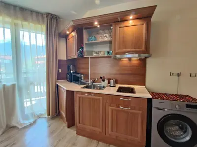 a kitchen with a sink and a washing machine at Fenix Emerald in Bansko