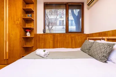 a bedroom with a large white bed and a window at The Crash Pad Studio by Flat Mаnager in Plovdiv