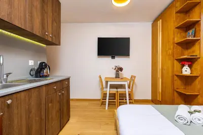 a kitchen with a sink and a table in a room at The Crash Pad Studio by Flat Mаnager in Plovdiv