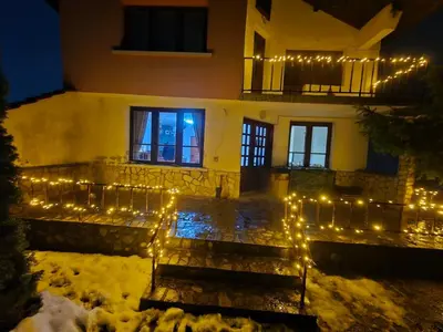 a house with christmas lights in the snow at BoroVille in Raduil