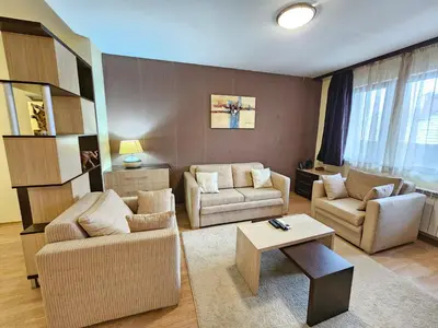 a living room with two couches and a coffee table at Two charming Studios in Trinity Bansko with balcony and free parking by Flat Mаnager in Bansko