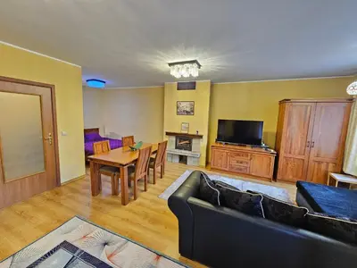 a living room with a couch and a table at Two charming Studios in Trinity Bansko with balcony and free parking by Flat Mаnager in Bansko