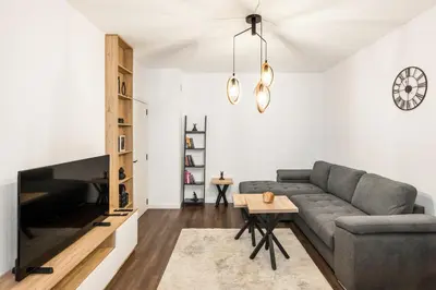 a living room with a couch and a table at AGIA 3-comfort apartment Sofia in Sofia