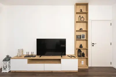 a living room with a television on a white cabinet at AGIA 3-comfort apartment Sofia in Sofia
