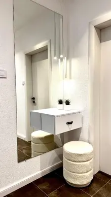 a bathroom with a vanity with a mirror and two stools at AGIA 3-comfort apartment Sofia in Sofia