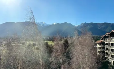 a view of a hotel with mountains in the background at TERRA Vista Penthouse near Pirin Golf and Bansko in Razlog