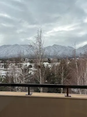 a view of snow covered mountains from a balcony at TERRA Vista Penthouse near Pirin Golf and Bansko in Razlog