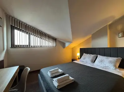 a bedroom with a bed with two towels on it at TERRA Vista Penthouse near Pirin Golf and Bansko in Razlog