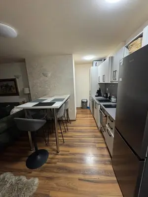 a small kitchen with a table and a refrigerator at JMN Pamporovo in Pamporovo