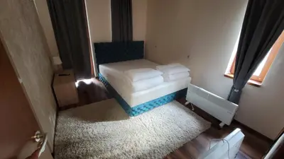 a small room with a bed and a window at JMN Pamporovo in Pamporovo